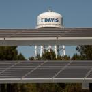 Image of UC Davis watertower in the background with solar panels in the foreground.